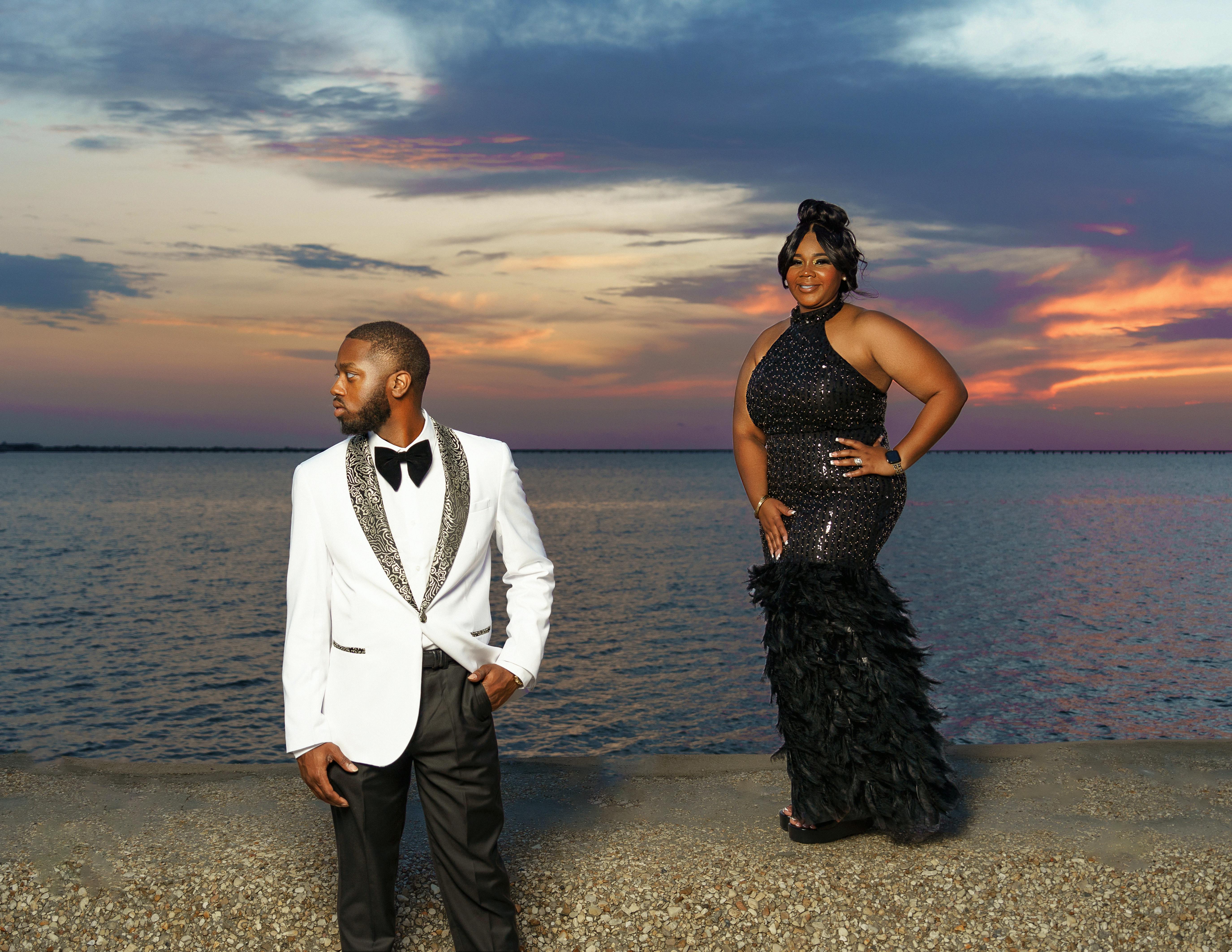 Couple at sunset by Lake Pontchartrain in New Orleans.