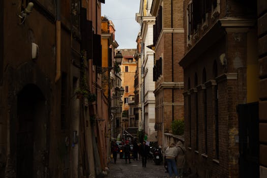 A narrow cobbled street lined with historical buildings, capturing urban European charm.