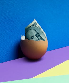 A cracked egg revealing US dollar bill against a vibrant abstract background, symbolizing financial growth.