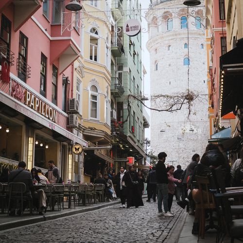 Free Lively street with cafes and Galata Tower in Istanbul. Perfect for travel inspiration. Stock Photo