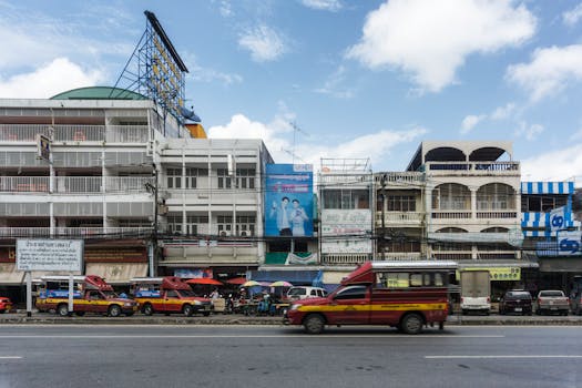 Vibrant street scene showcasing urban architecture and transportation in Chiang Rai, Thailand.