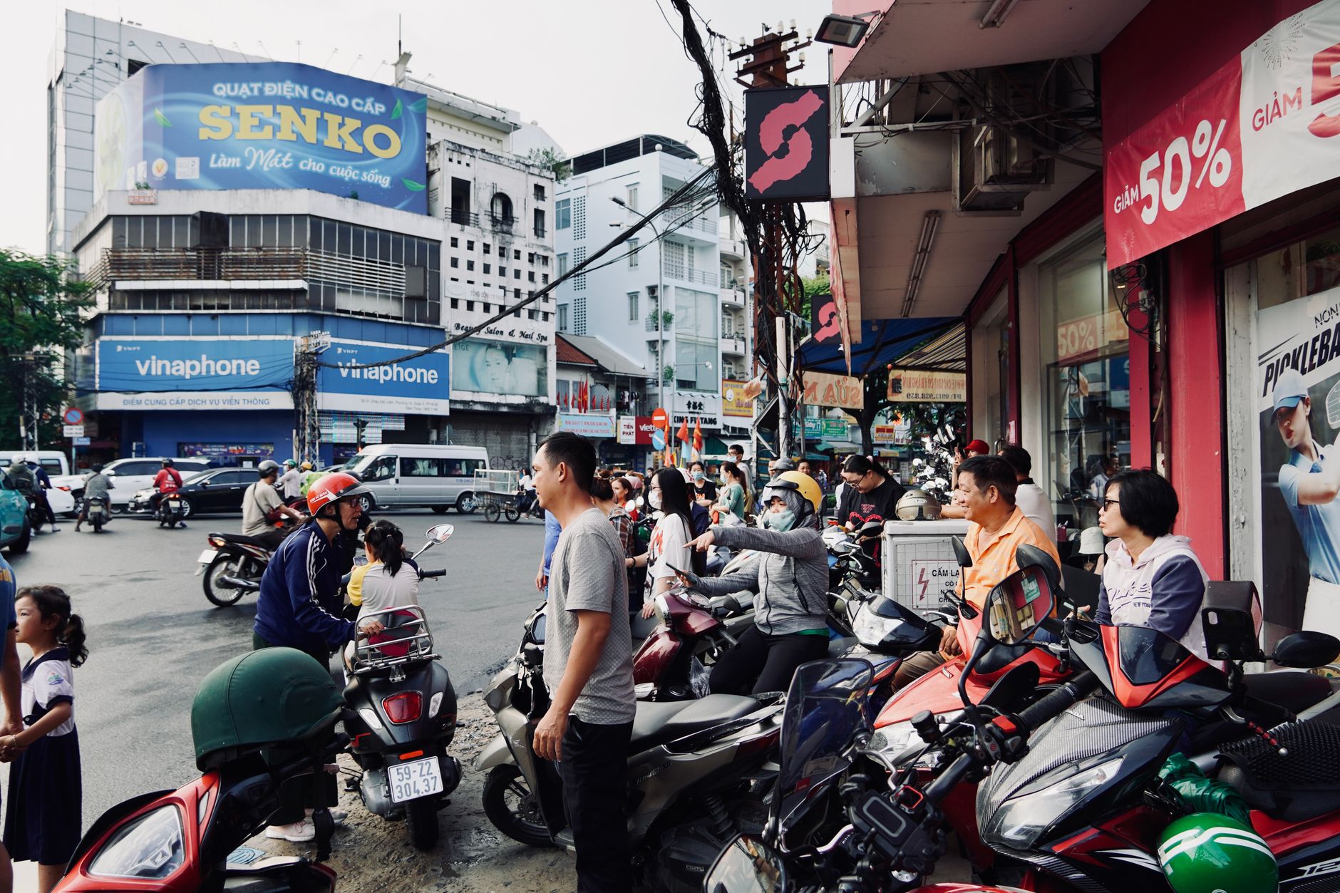Lively street scene with people on motorbikes in Vietnam.