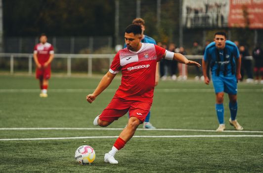 Football player in action on the pitch, showcasing athletic skill.