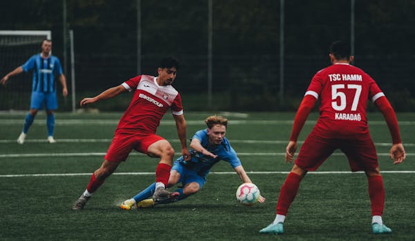 Dynamic capture of soccer players in action during a competitive match on a grassy field.