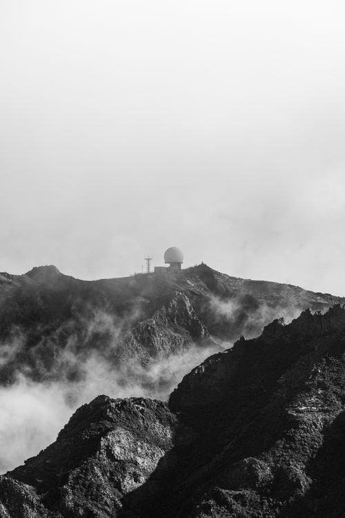 Free Black and white photo of Madeira's rugged mountains with fog and distant radar dome. Stock Photo