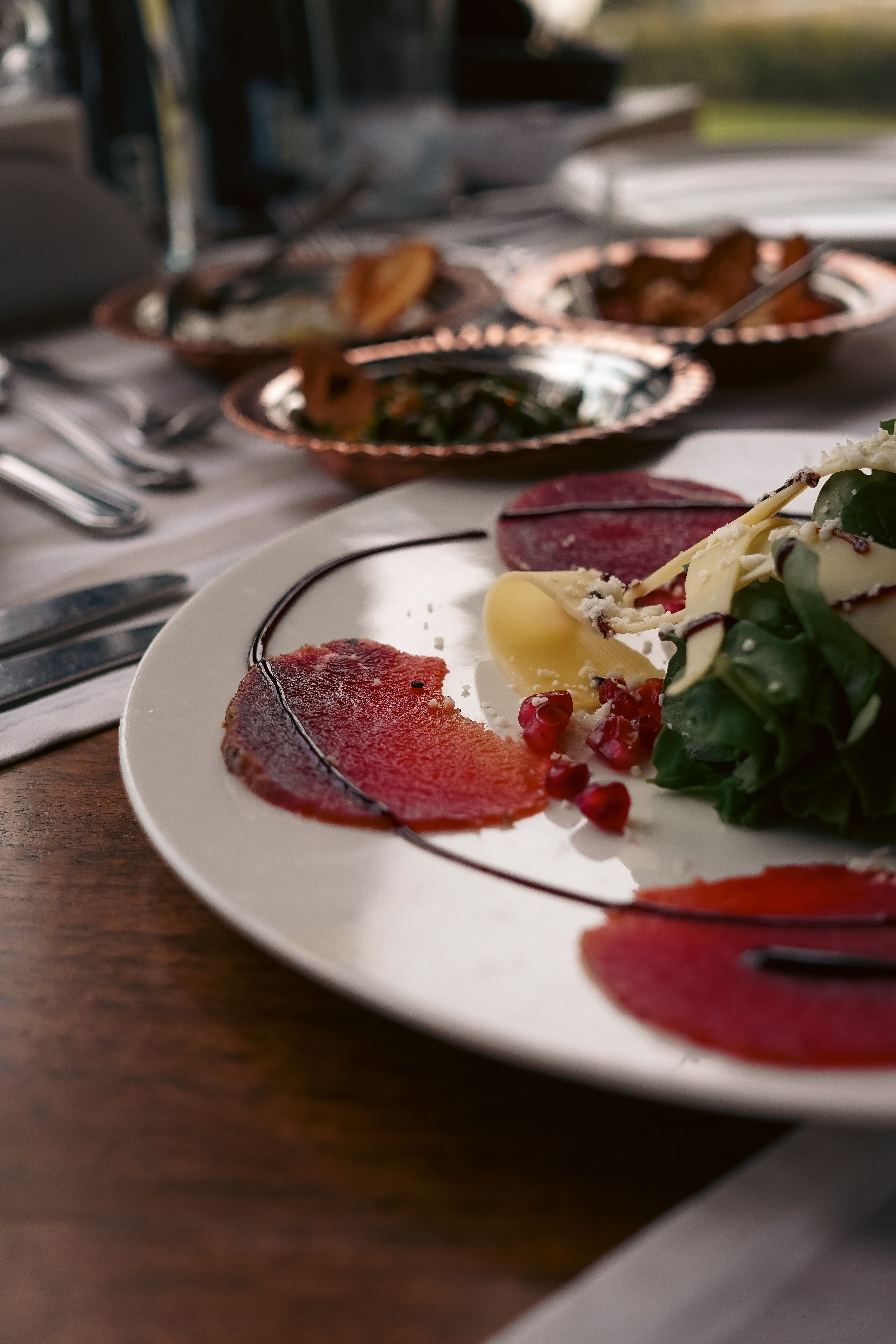 Artistic presentation of a gourmet salad with beetroot and fresh greens, perfect for food enthusiasts.