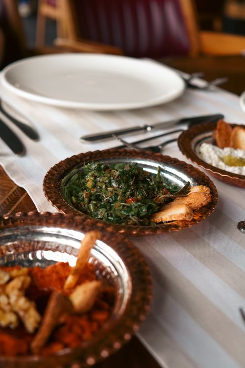 Free Authentic Turkish meze dishes served on copper plates in a rustic setting. Stock Photo