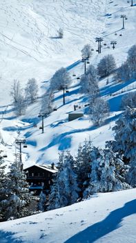 A breathtaking snowy mountain scene with ski lifts and snow-covered trees under clear skies.