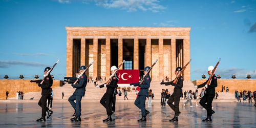 Free Soldiers performing a ceremonial march at Anıtkabir with Turkish flag in the background. Stock Photo