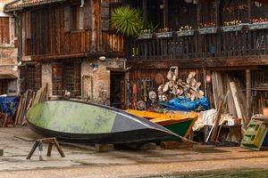 Black and white study of moored dugout canoes — photo by Simon on Pexels