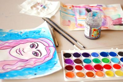 Watercolour lettering piece with paint set and brushes — photo by Lisa Stroud on Pexels