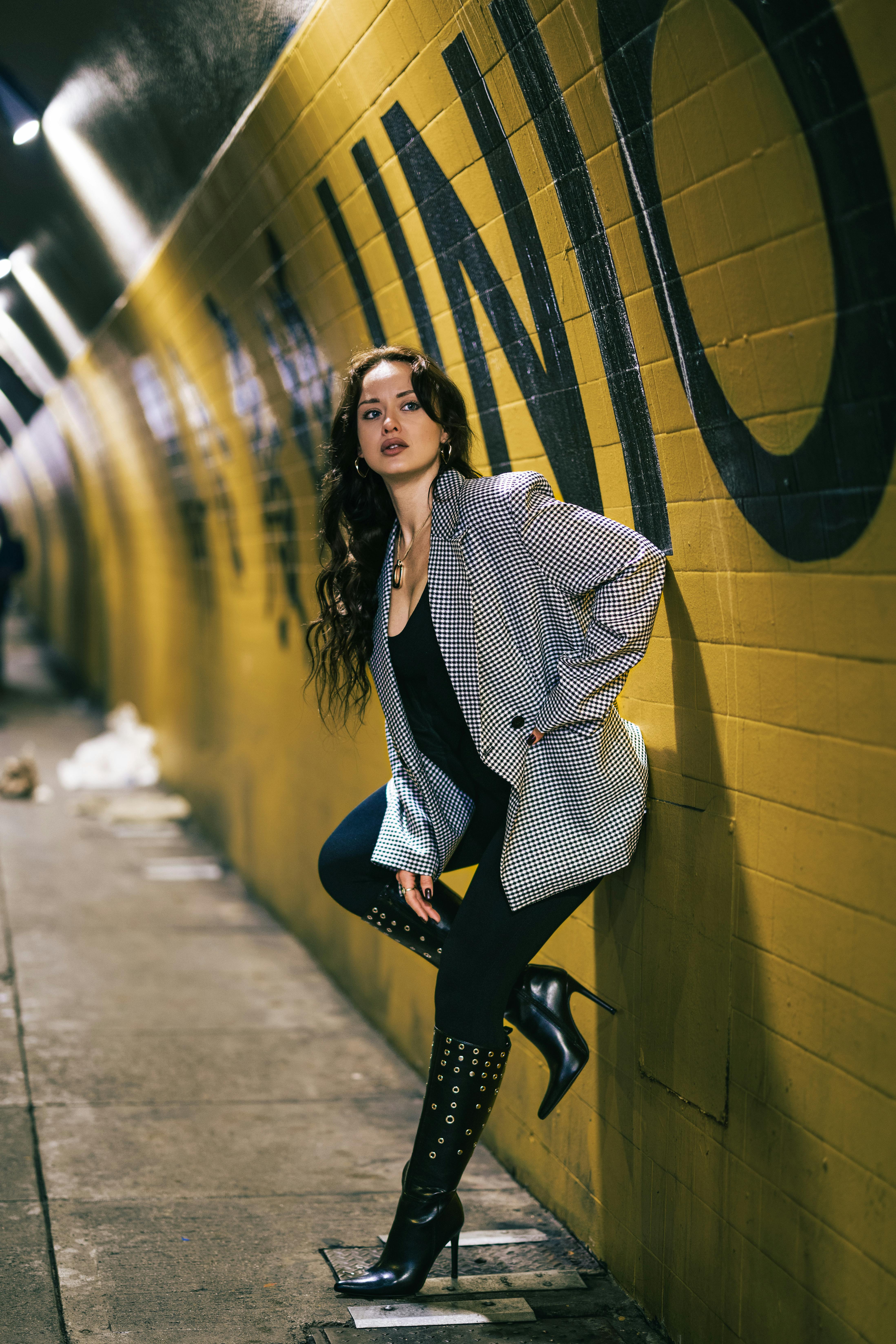 fashionable woman in urban tunnel at night