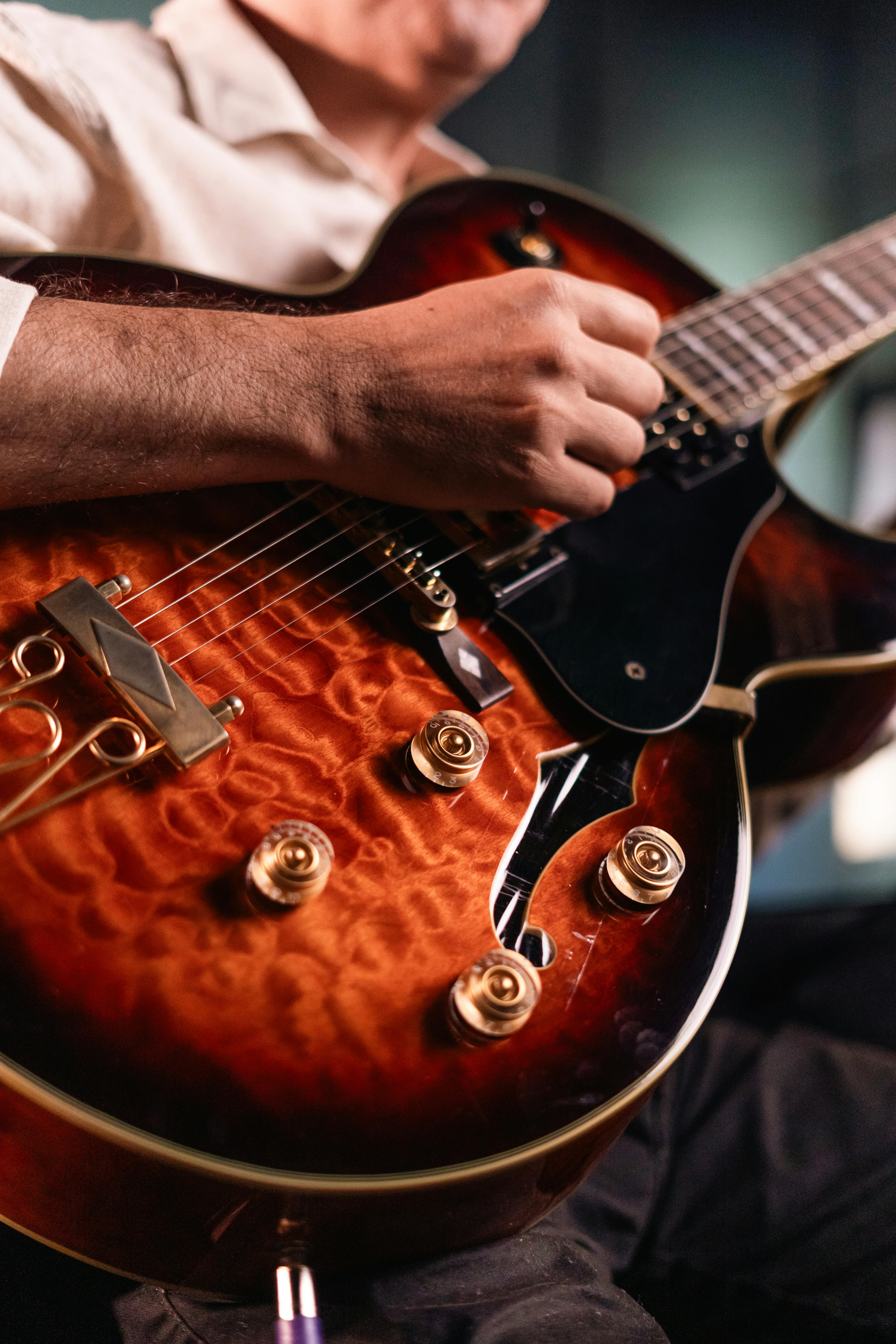 A male musician skillfully playing an electric guitar at a live concert.
