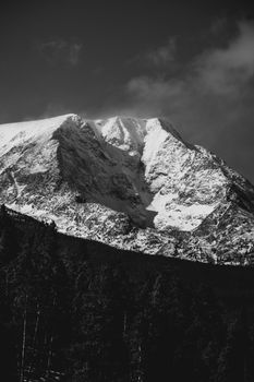Captivating view of a snowy mountain under clear skies in black and white.
