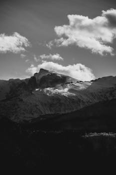Dramatic black and white view of Rocky Mountains under cloudy sky in Colorado.
