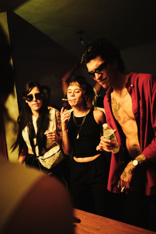 Free A group of friends partying indoors with neon lights and vibrant atmosphere in Leon, Mexico. Stock Photo