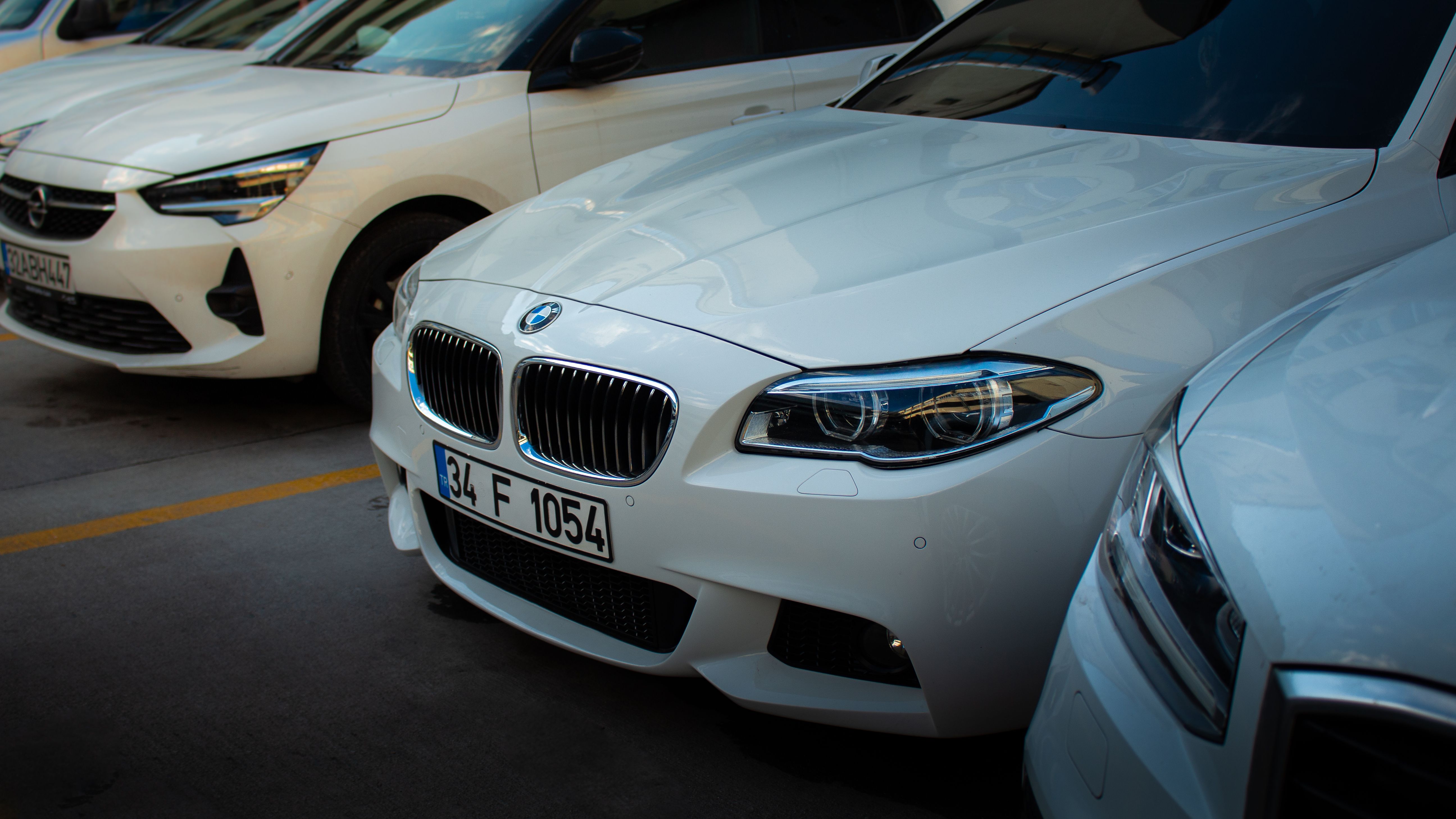 White BMW Car in Urban Parking Lot · Free Stock Photo