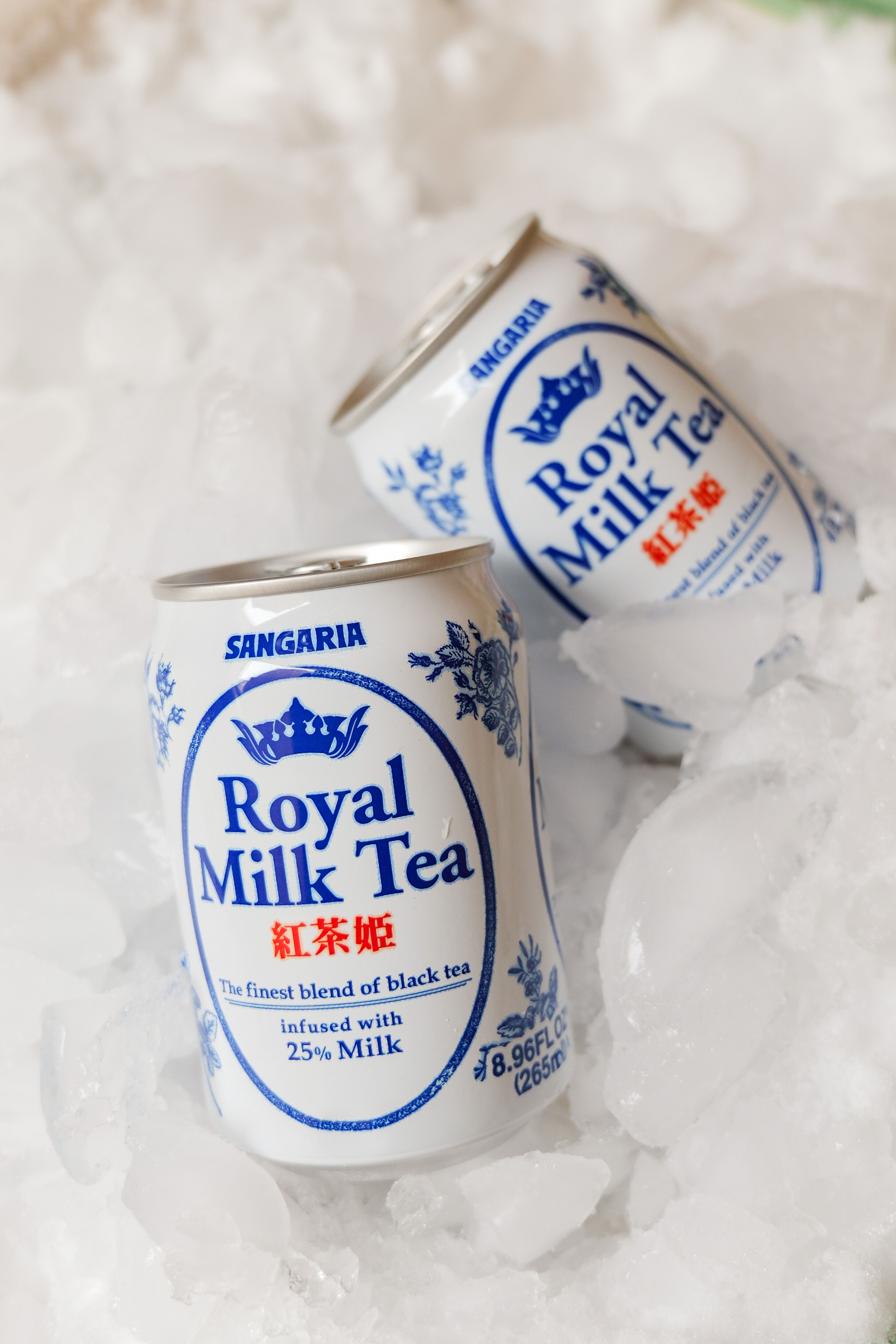 Chilled Sangaria Royal Milk Tea cans resting on ice for a refreshing beverage experience.