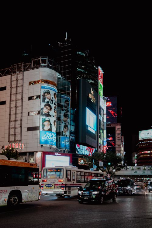 Free Vibrant nightlife in Shibuya, Tokyo with illuminated billboards and traffic. Stock Photo