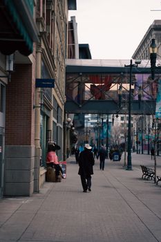 Street view of downtown Calgary with pedestrians and modern architecture.