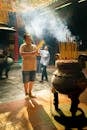 Man Performing Ritual at Ong Bon Temple in Vietnam