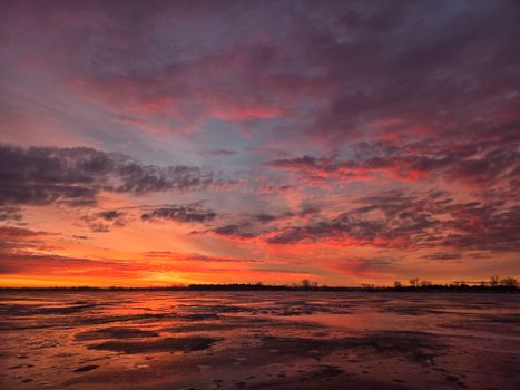Captivating winter sunset with vivid colors over a serene South Dakota landscape.