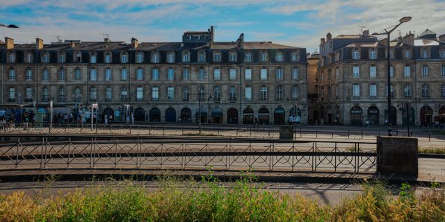 Elegant historic buildings in Bordeaux, France under a clear blue sky.