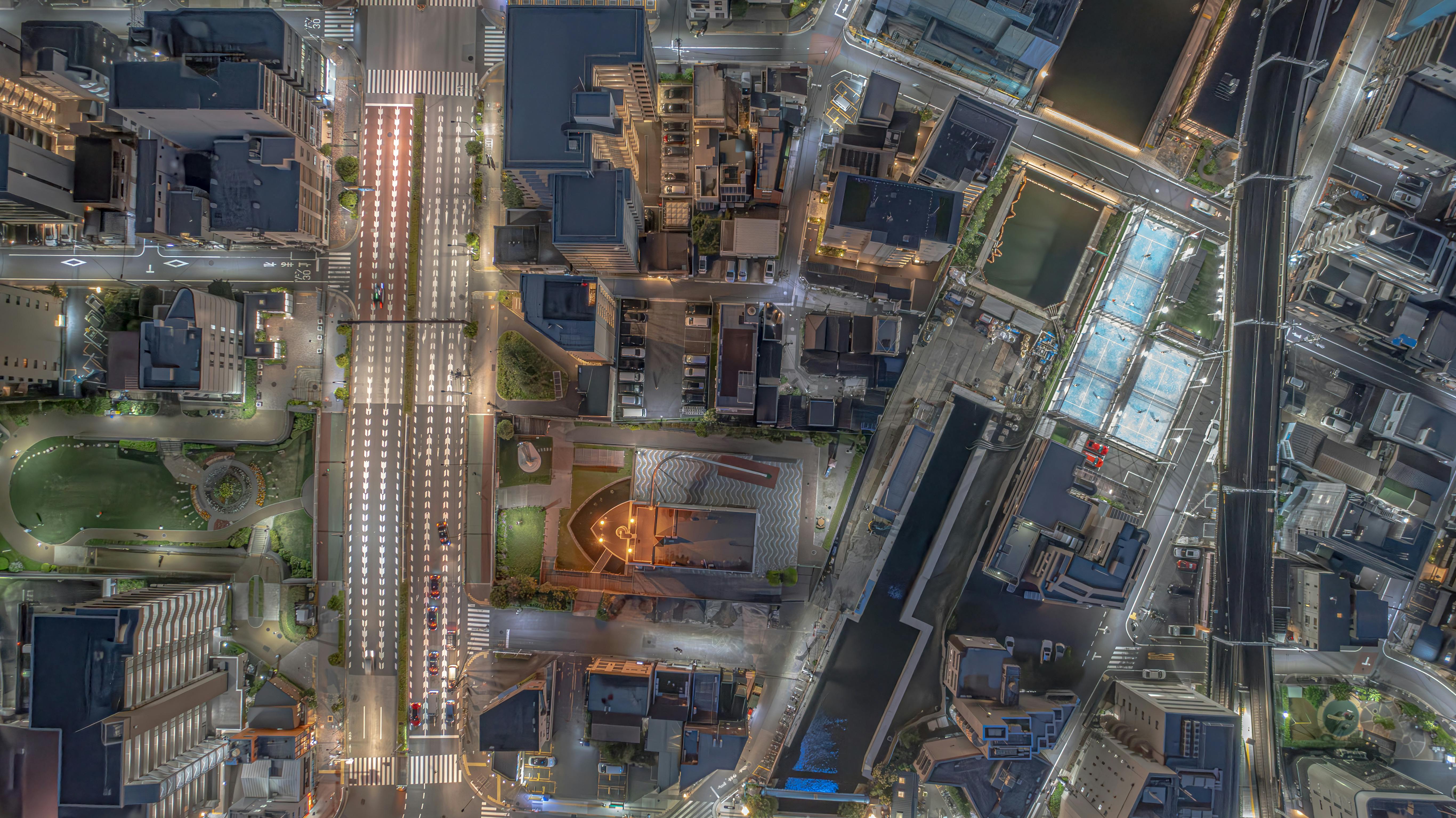 Stunning aerial view of Sumida City, Tokyo at night, highlighting vibrant city streets and architecture.