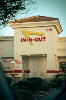 Exterior of In-N-Out Burger with recognizable logo and building number 1170.