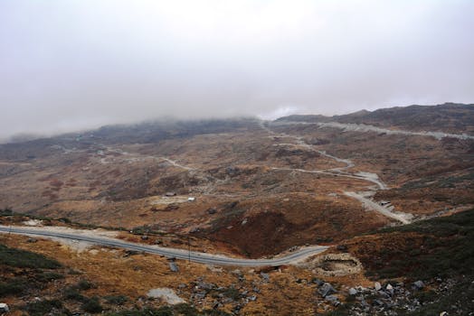 Winding road through mist-covered mountains in Gangtok, Sikkim, India.