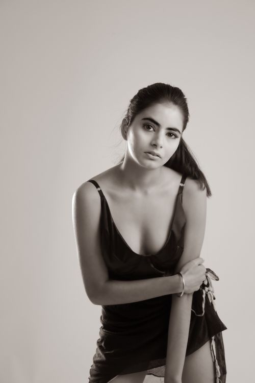 Free Black and white portrait of a young woman in an elegant dress, exuding sophistication. Stock Photo