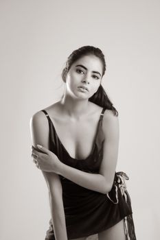 Artistic black and white portrait of a woman in a stylish dress, elegant and timeless.