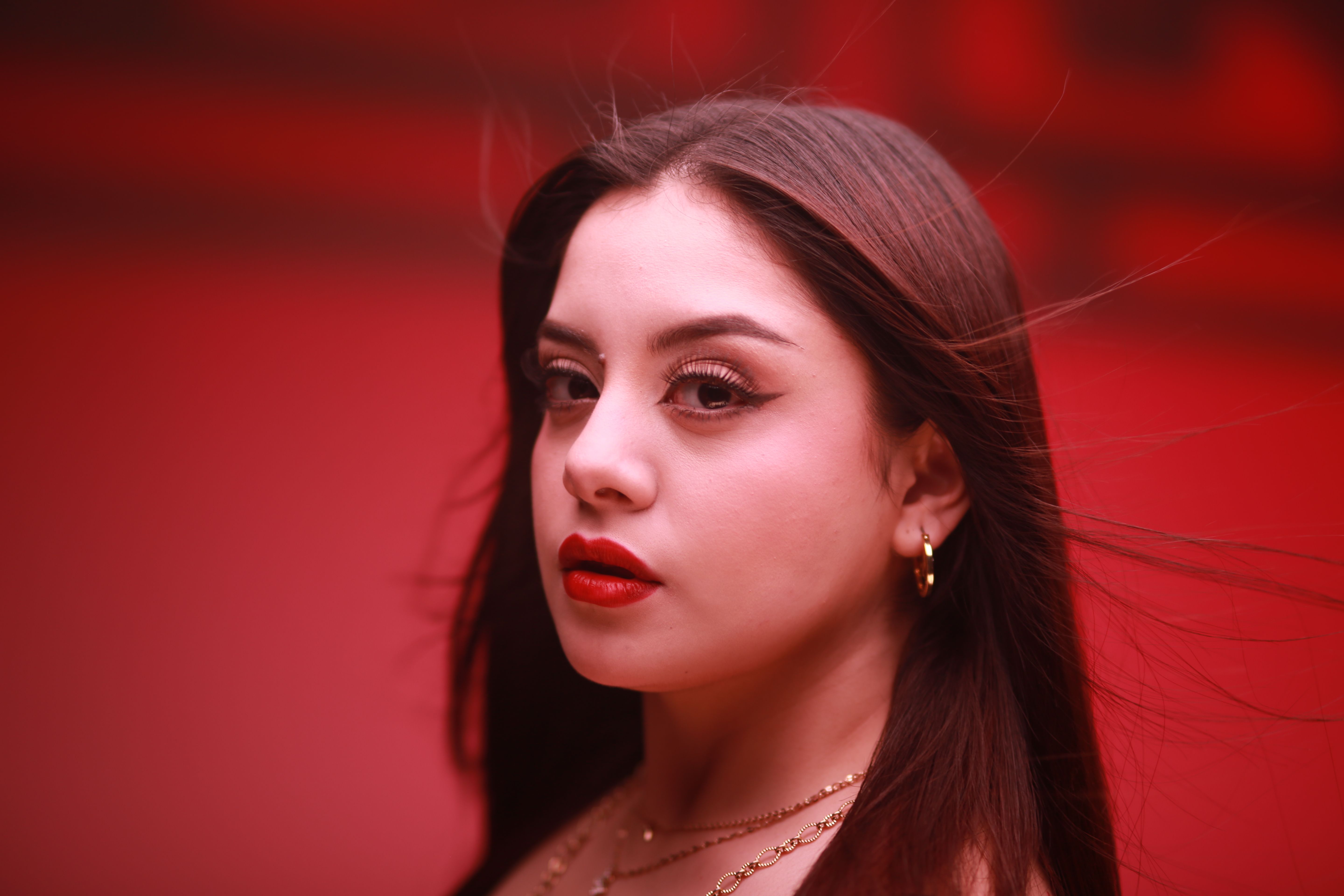 Stunning Portrait of Woman in Red Background · Free Stock Photo