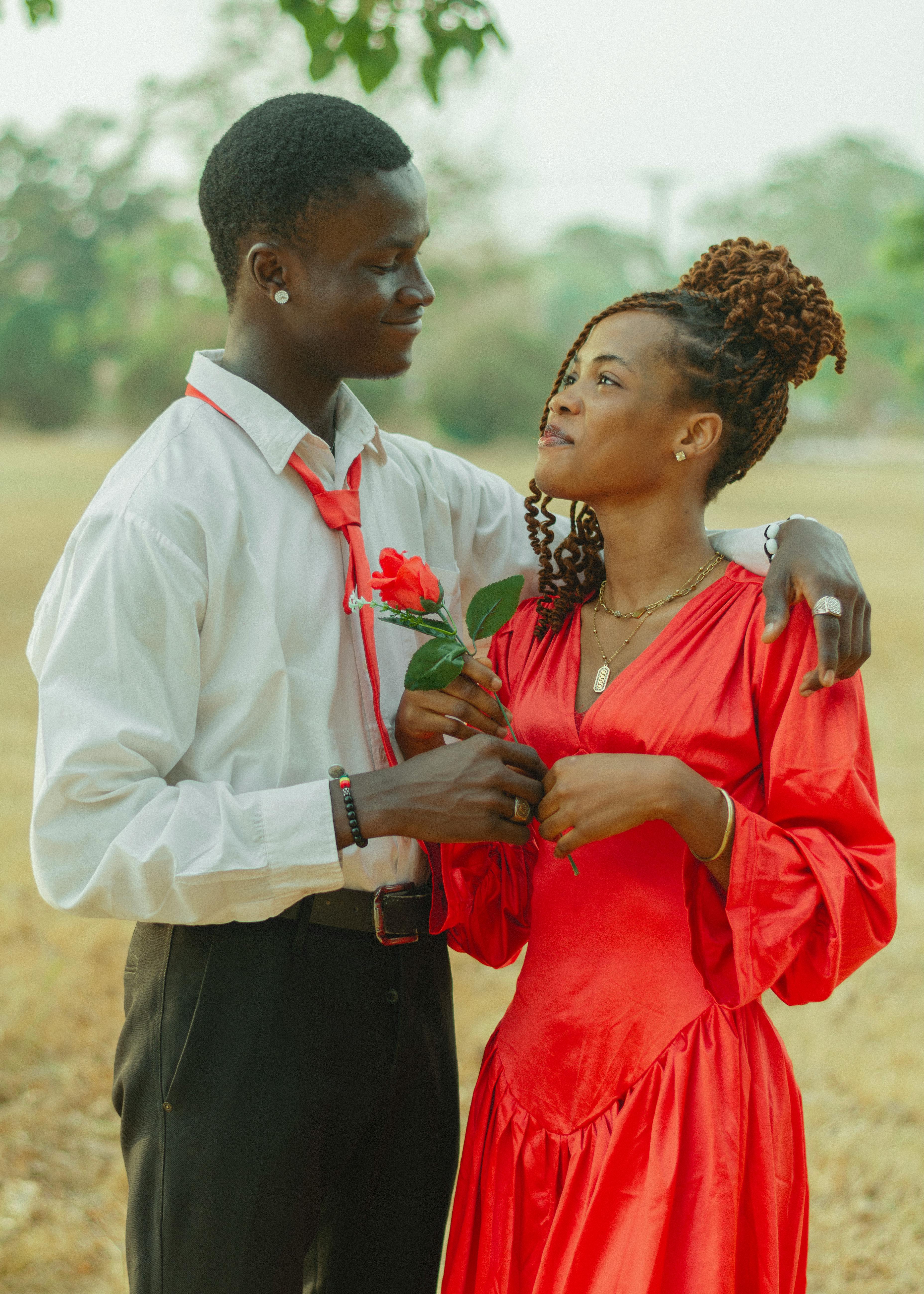 A loving couple shares a romantic moment outdoors, perfect for Valentine's Day themes.