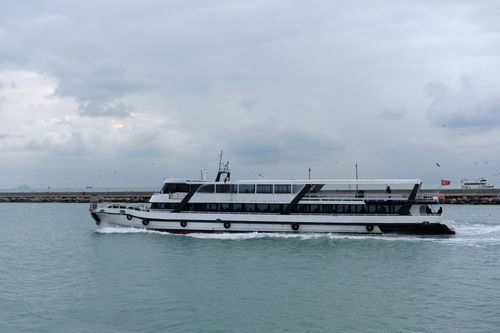 Free Modern passenger ferry cruising through Istanbul's waters with an overcast sky backdrop. Stock Photo