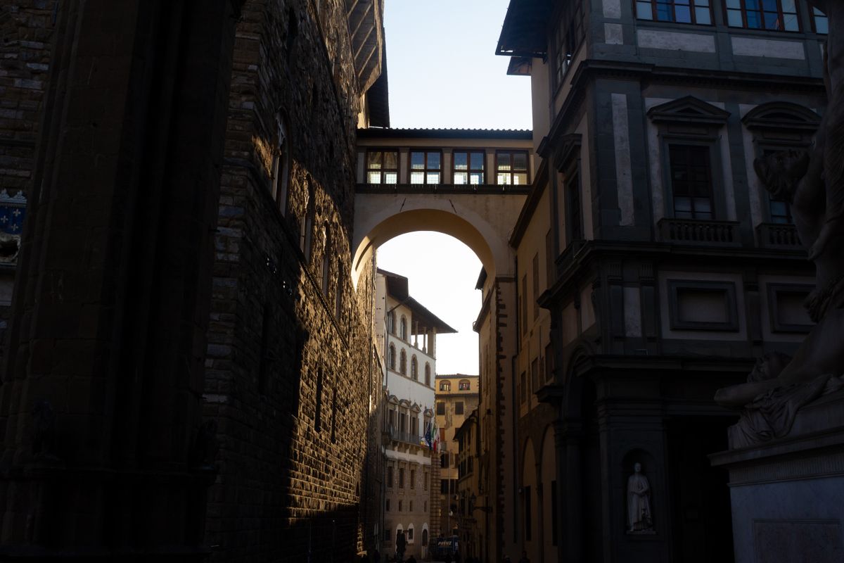 Florence renaissance street architecture stone palazzo with arched windows and ochre Tuscan plaster