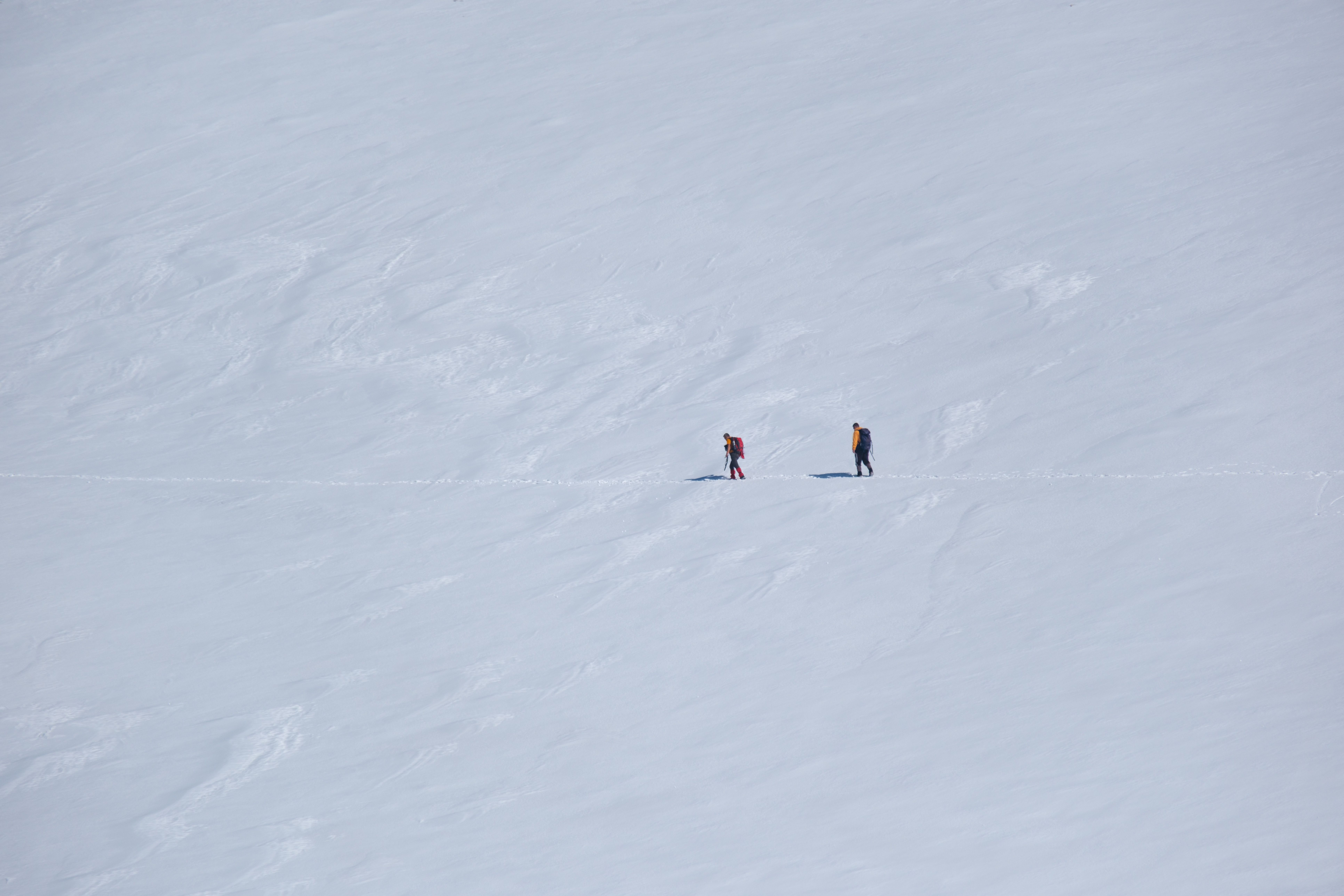 hikers scaling a snowy mountain, adventurous travel scene