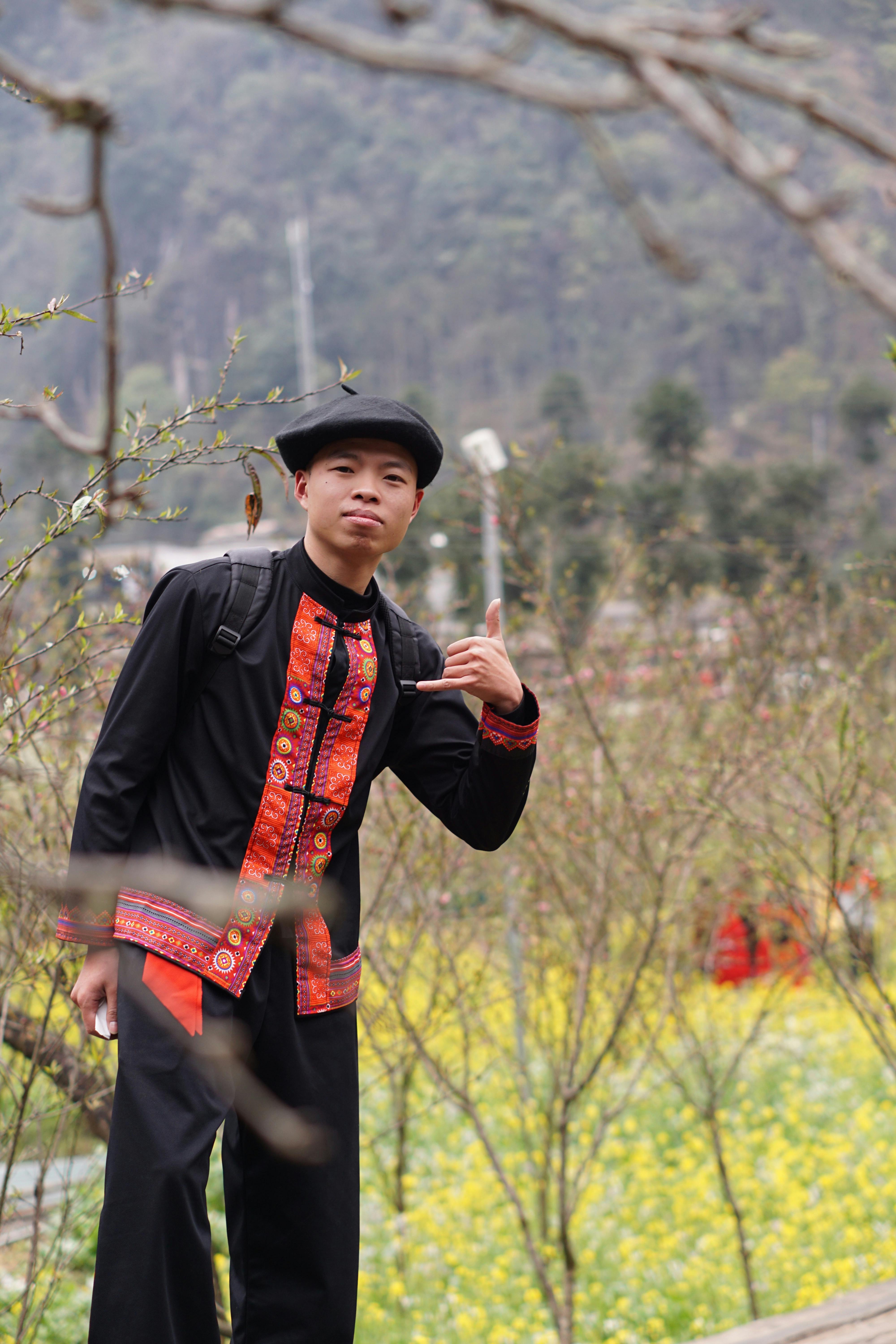 Man in traditional attire amidst blooming nature