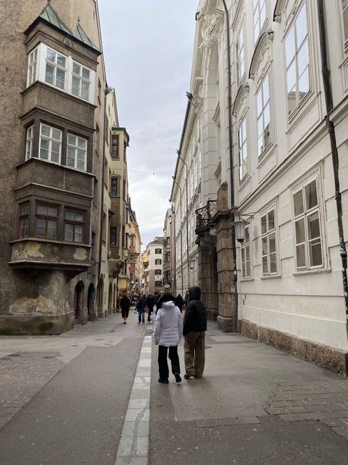 Free A quaint European street with tourists exploring historic architecture. Stock Photo