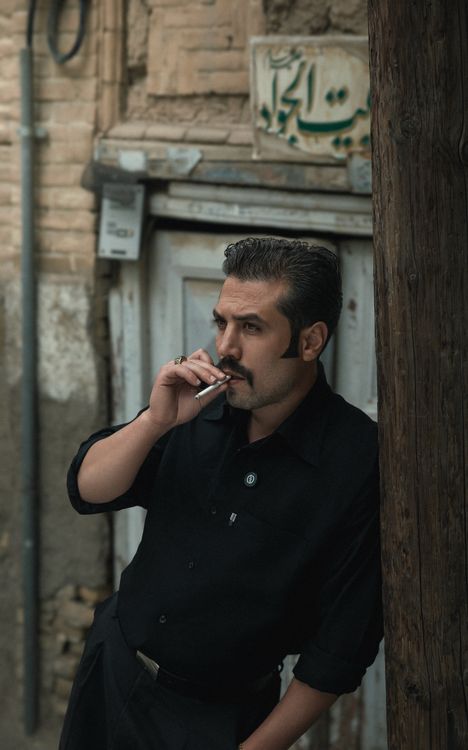 Man Smoking in Urban Alleyway Setting · Free Stock Photo
