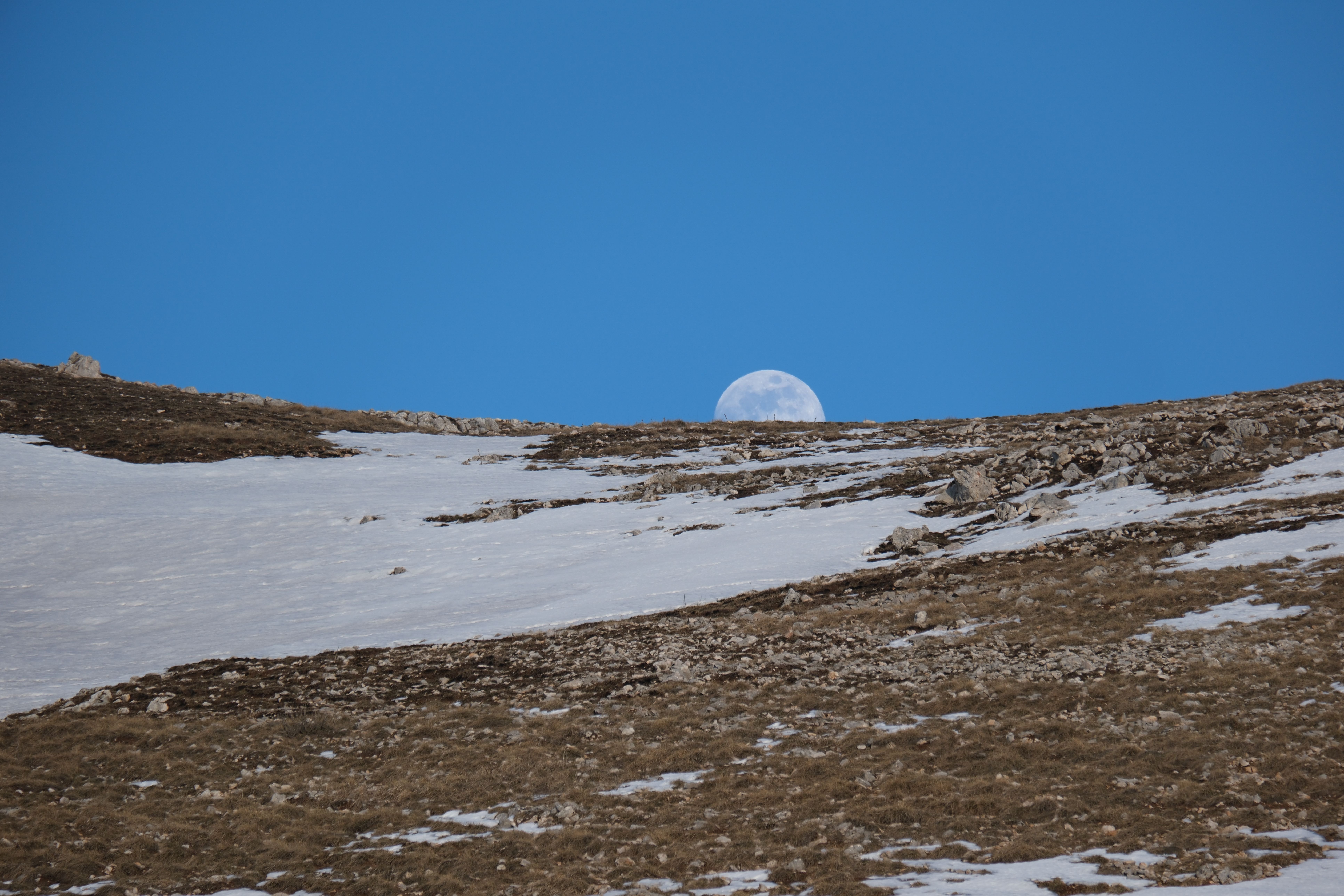 Half Moon Rising Over Snowy Mountain Landscape · Free Stock Photo