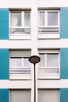 Symmetrical facade featuring blue and white panels with a single streetlight.