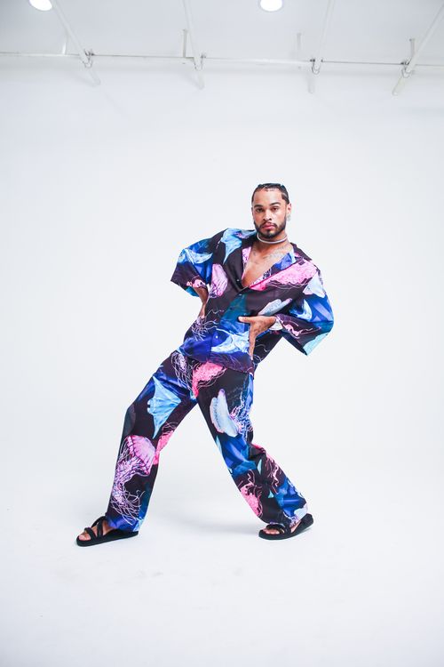 Free A striking portrait of an adult in vibrant, modern attire posing confidently. Stock Photo