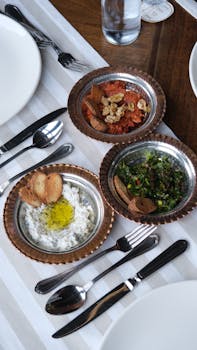 Elegant display of Mediterranean meze dips with fresh bread, ideal for sharing.