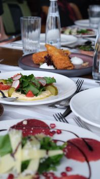 A refined dining table with enticing gourmet dishes elegantly arranged, perfect for culinary events.