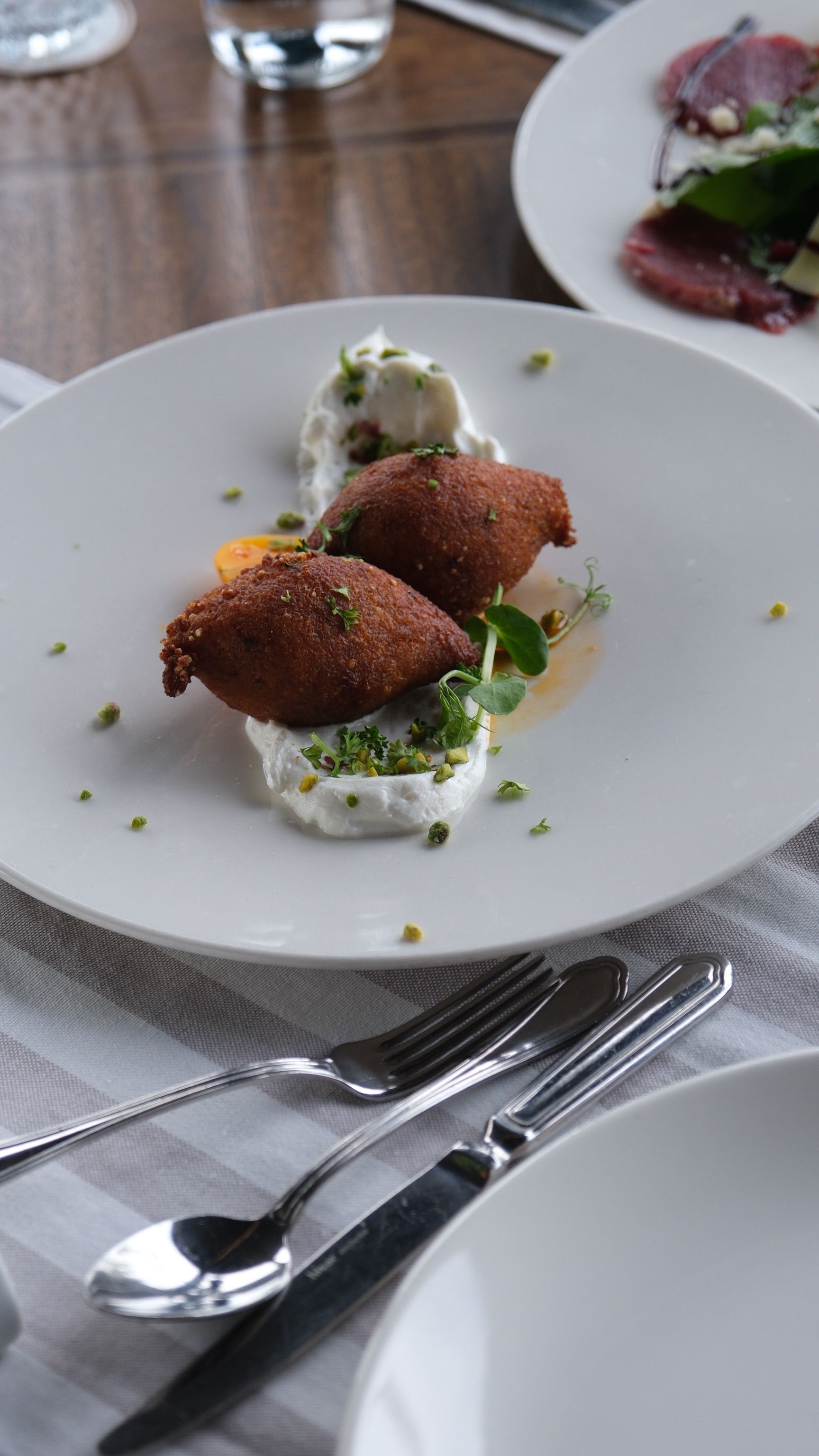 Delicious kibbeh dish served elegantly with garnish on a white plate.