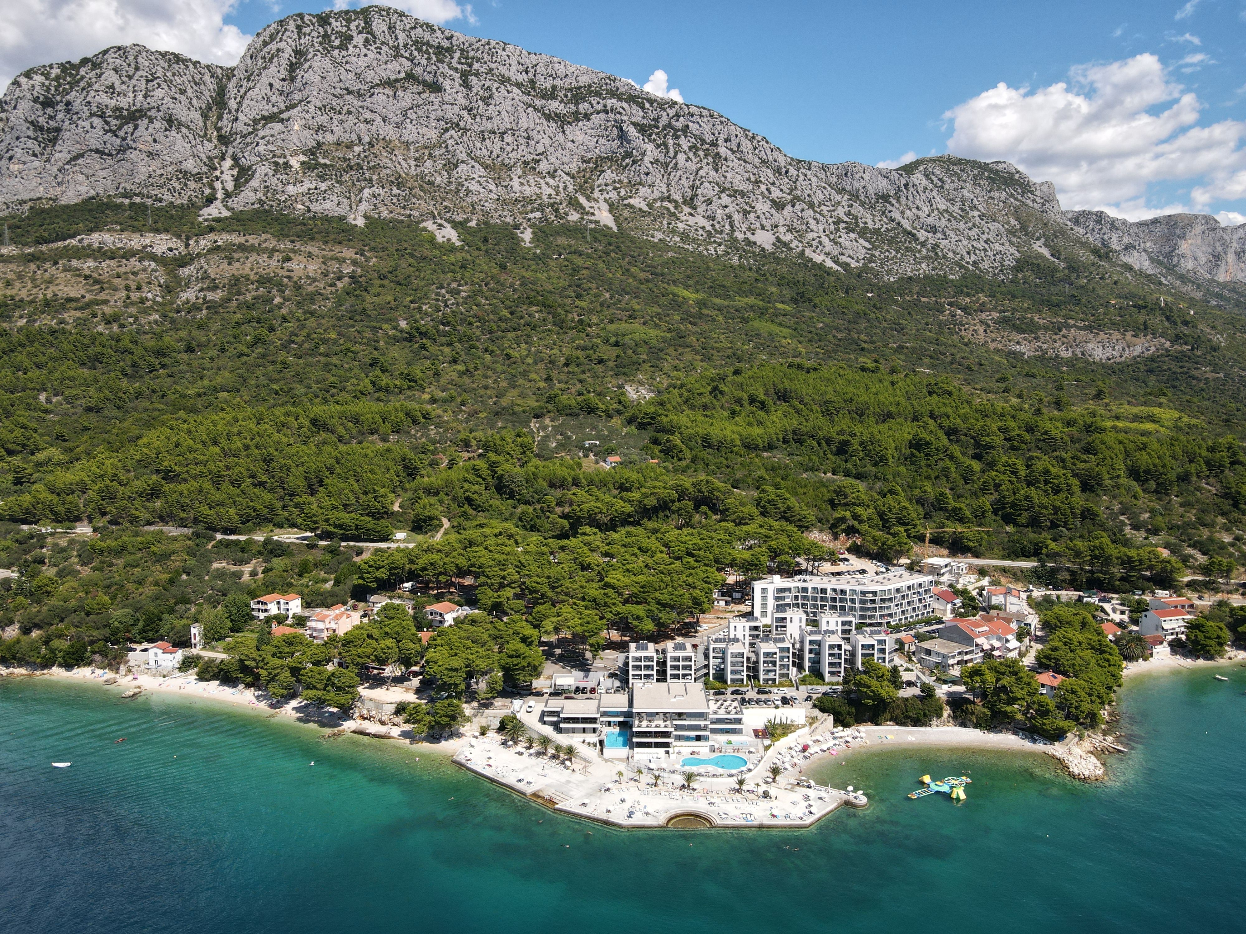 Scenic aerial view of Podaca, Croatia with stunning coastline and lush mountains.