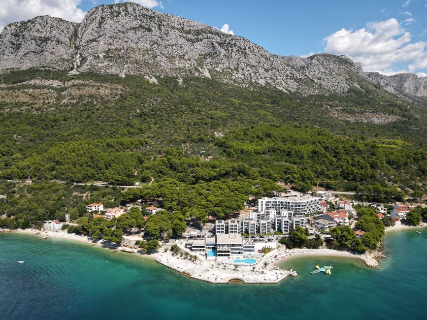 Scenic aerial view of Podaca, Croatia with stunning coastline and lush mountains.