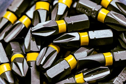 Detailed image of steel screwdriver bits with yellow bands.