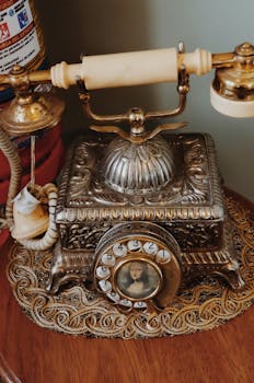 Ornately designed vintage rotary phone on display, reflecting antique craftsmanship.